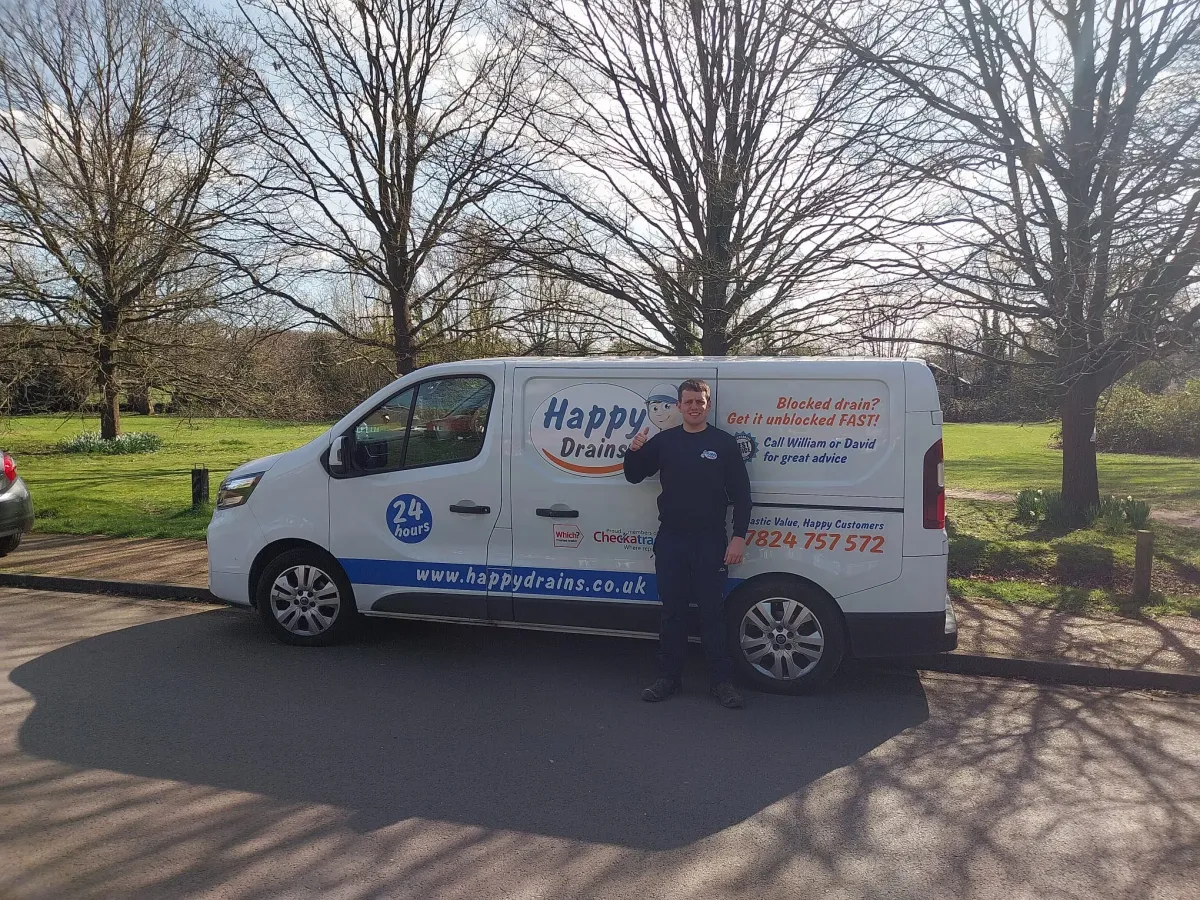 Happy Drains engineer with a branded service van — 24/7 drain unblocking across the UK